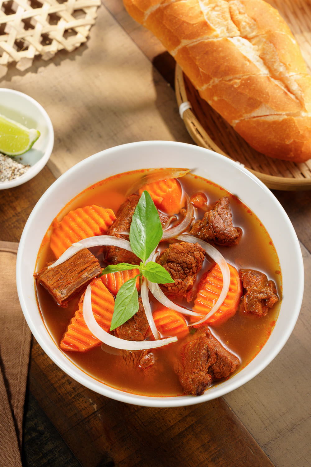 Vietnamese beef stew with carrot and onion, served with a baguette